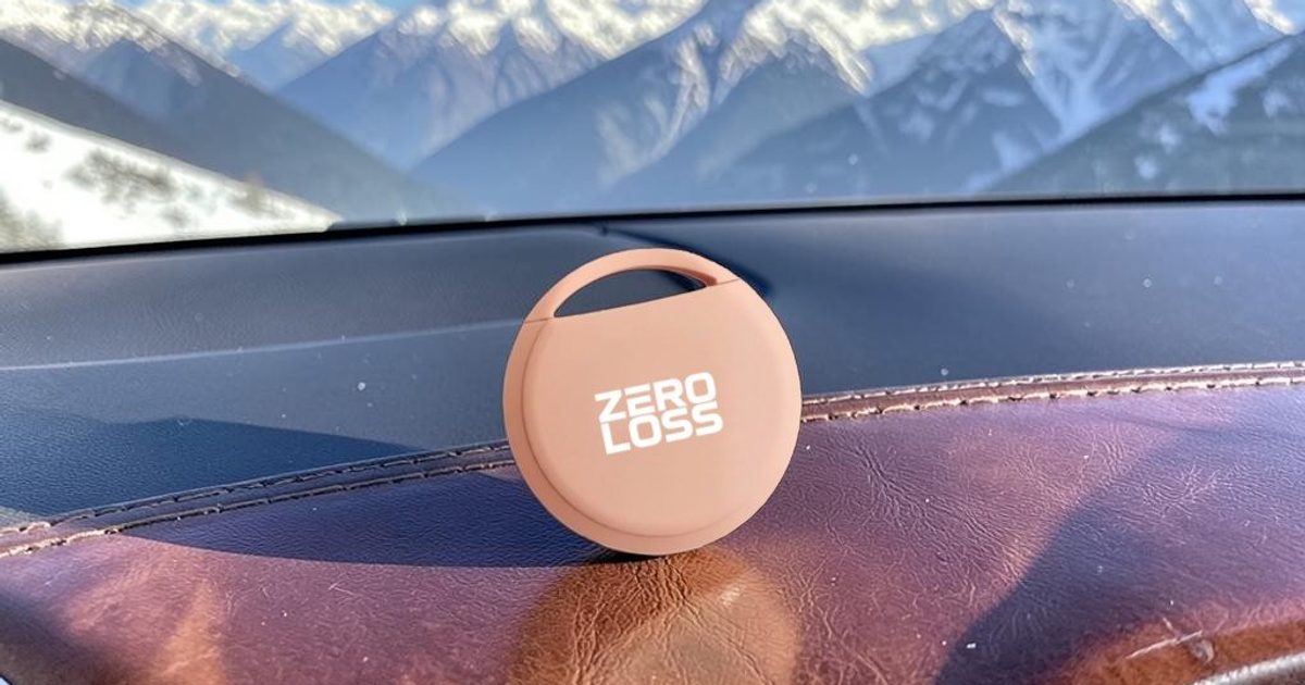The ZeroLoss tracker on a car dashboard with mountains beyond the windscreen
