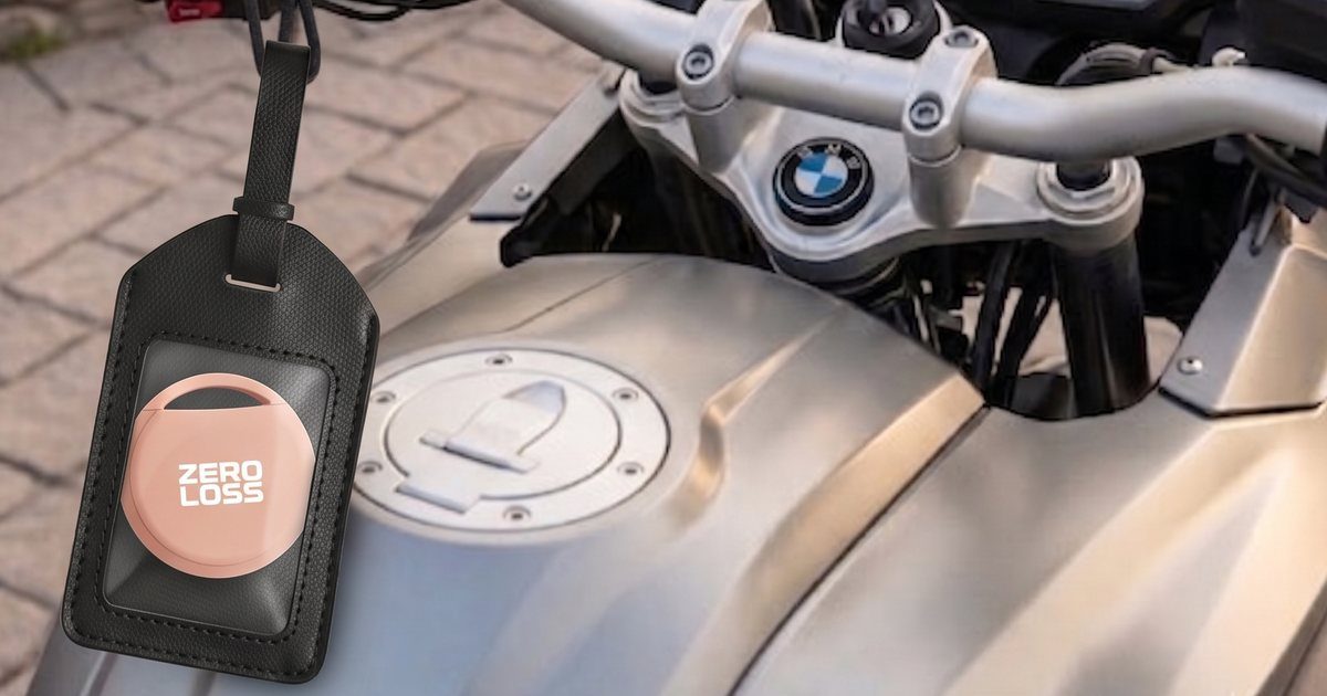 A ZeroLoss tracker in a leather tag hanging from a motorcycle handlebar
