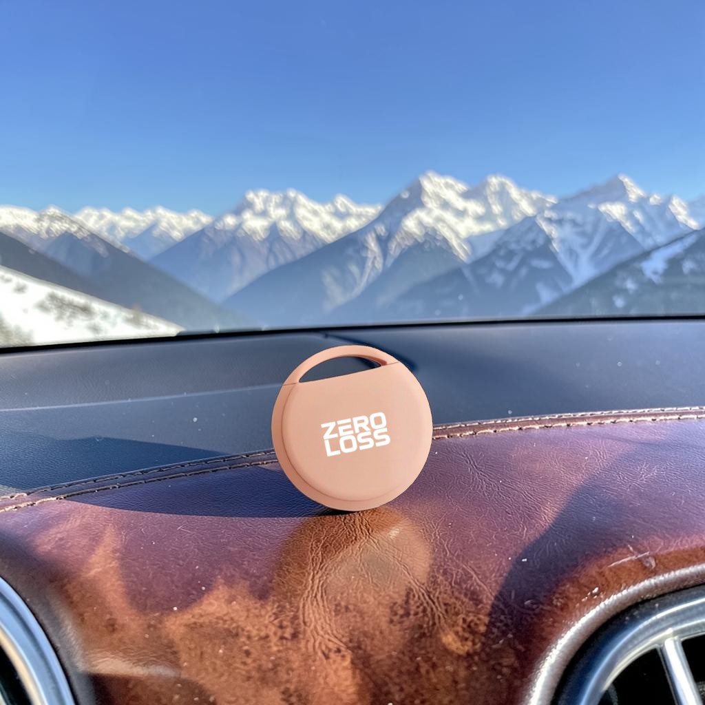 The ZeroLoss tracker resting on a car dashboard with mountains through the windscreen