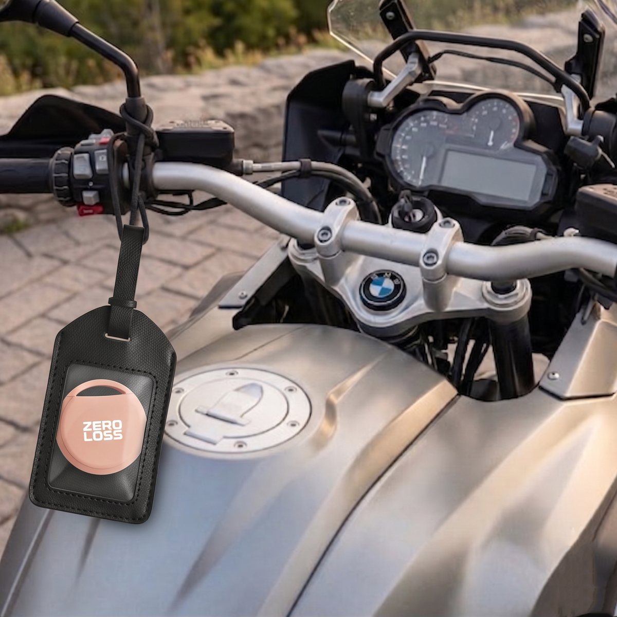 The ZeroLoss tracker in a leather tag hanging from a motorcycle handlebar